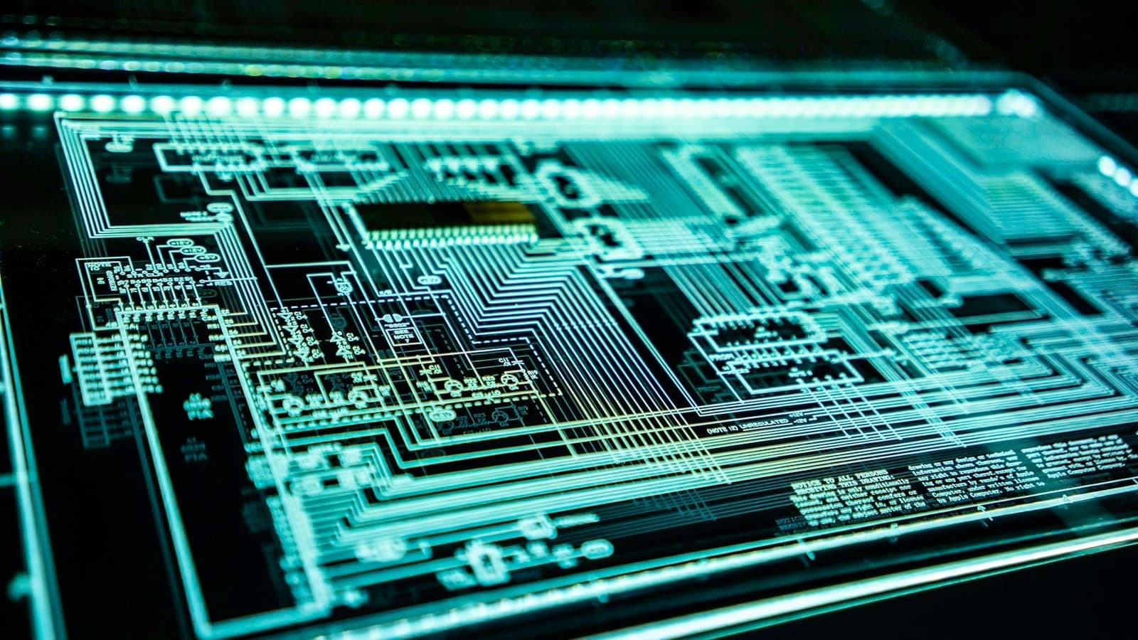 Luminous integrated microprocessor and electronic memory architecture schematic displayed on an illuminated technical drafting board